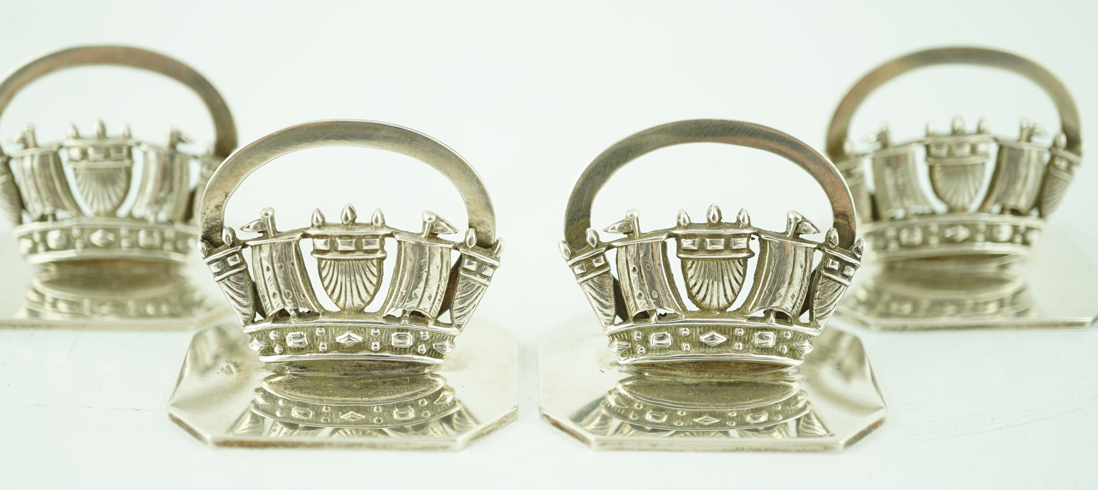 A set of four George V silver Royal Navy & Merchant Services menu holders, by John William Barrett